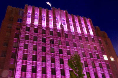 Larson Building Lit Up Pink To Spread Awareness