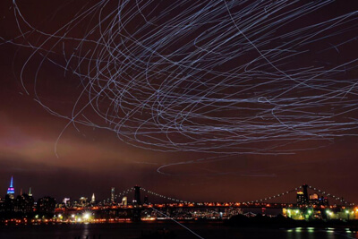 Pigeons illuminate New York skies